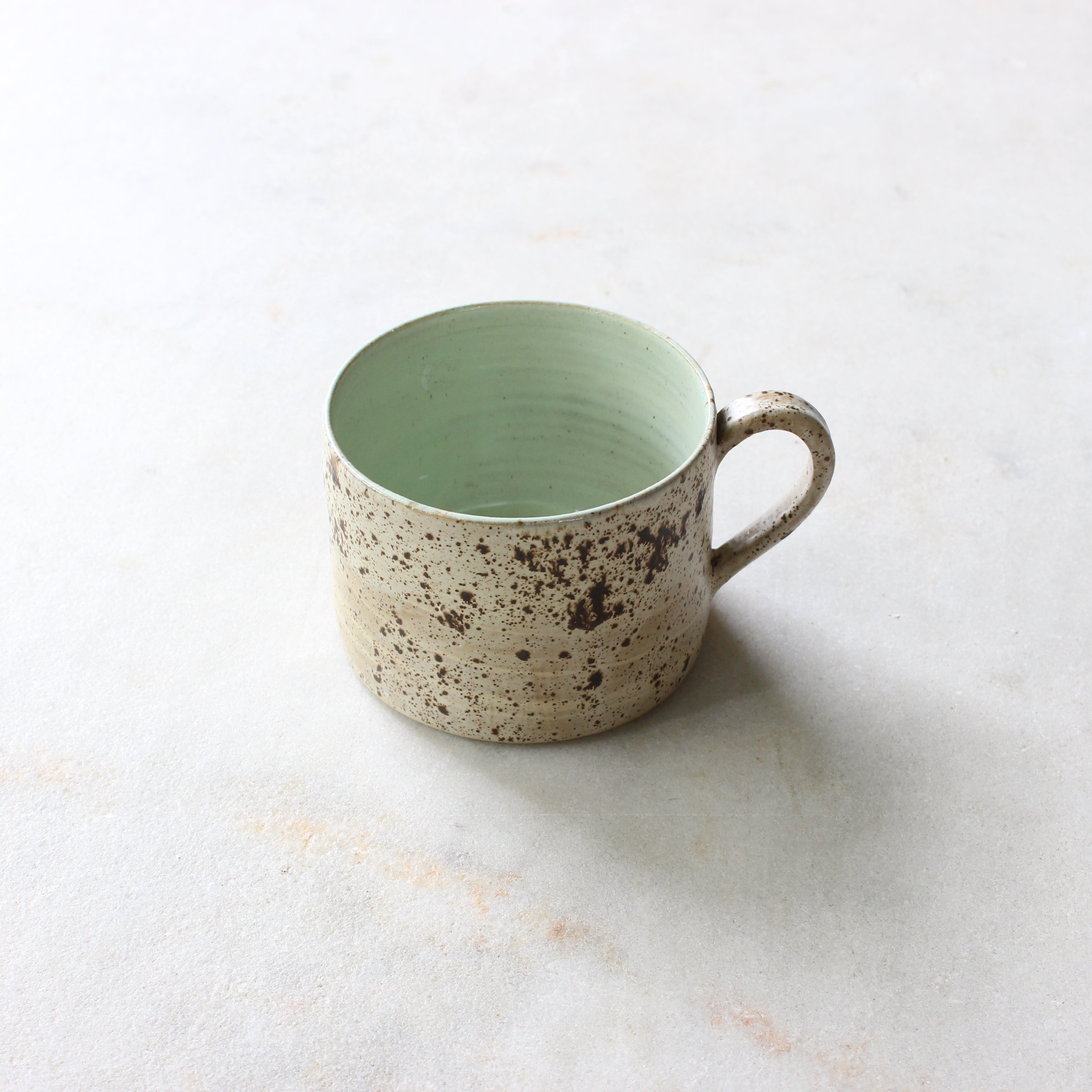 Speckled egg wide mug with melon green liner Ceramics D H Makers 